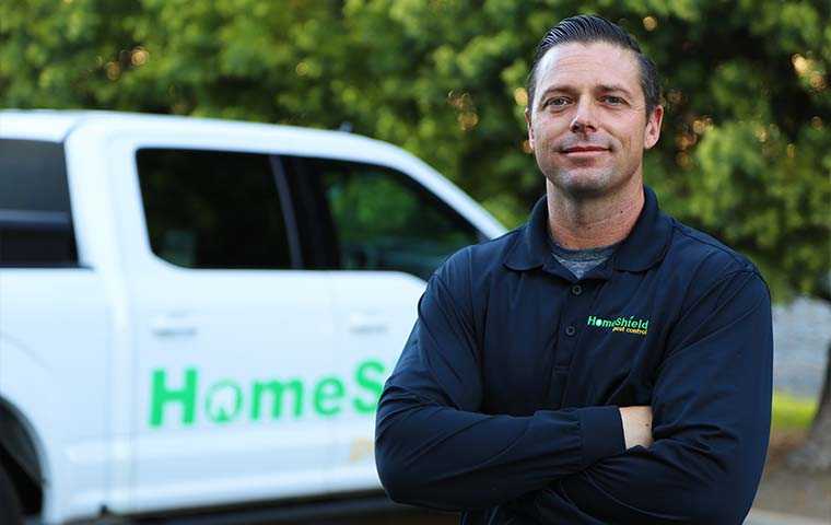 tech standing in front of homeshield truck