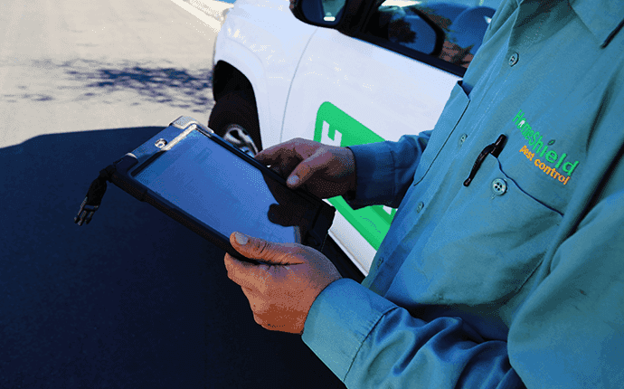 a technician using a tablet to inspect